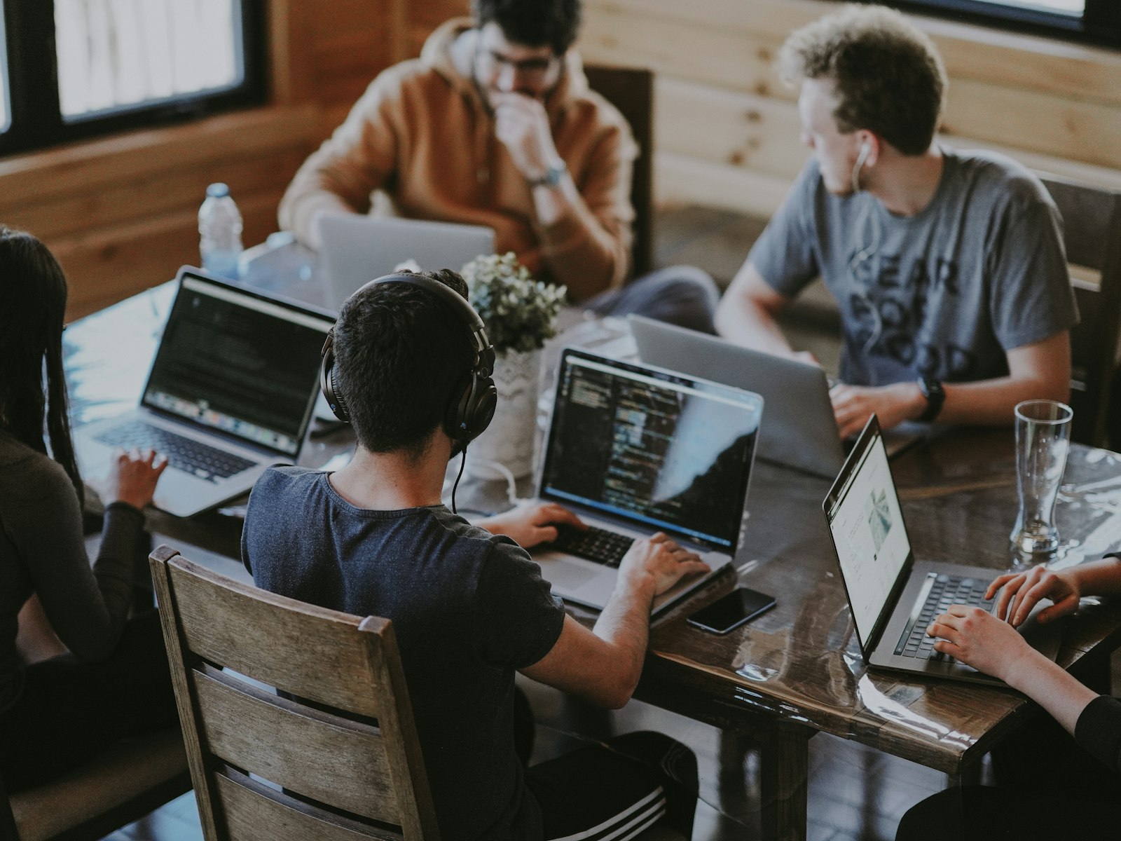 A team collaborating on laptops around a table